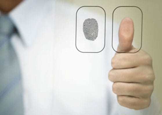 thumbprint pressing on glass